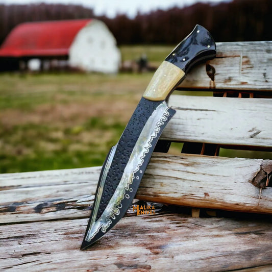 A Hunting Bowie Knife with a D2 steel blade, featuring a Camel Bone & Bull Horn handle, resting on a wooden surface with a blurred background.