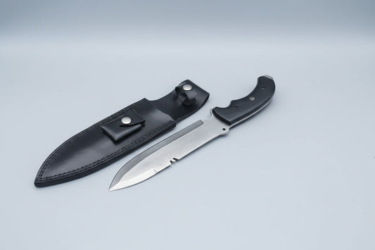 A hand holding a custom spear-point Bowie knife with a black G10 Micarta handle and a silver D2 steel blade, alongside a brown Cowhide leather sheath.