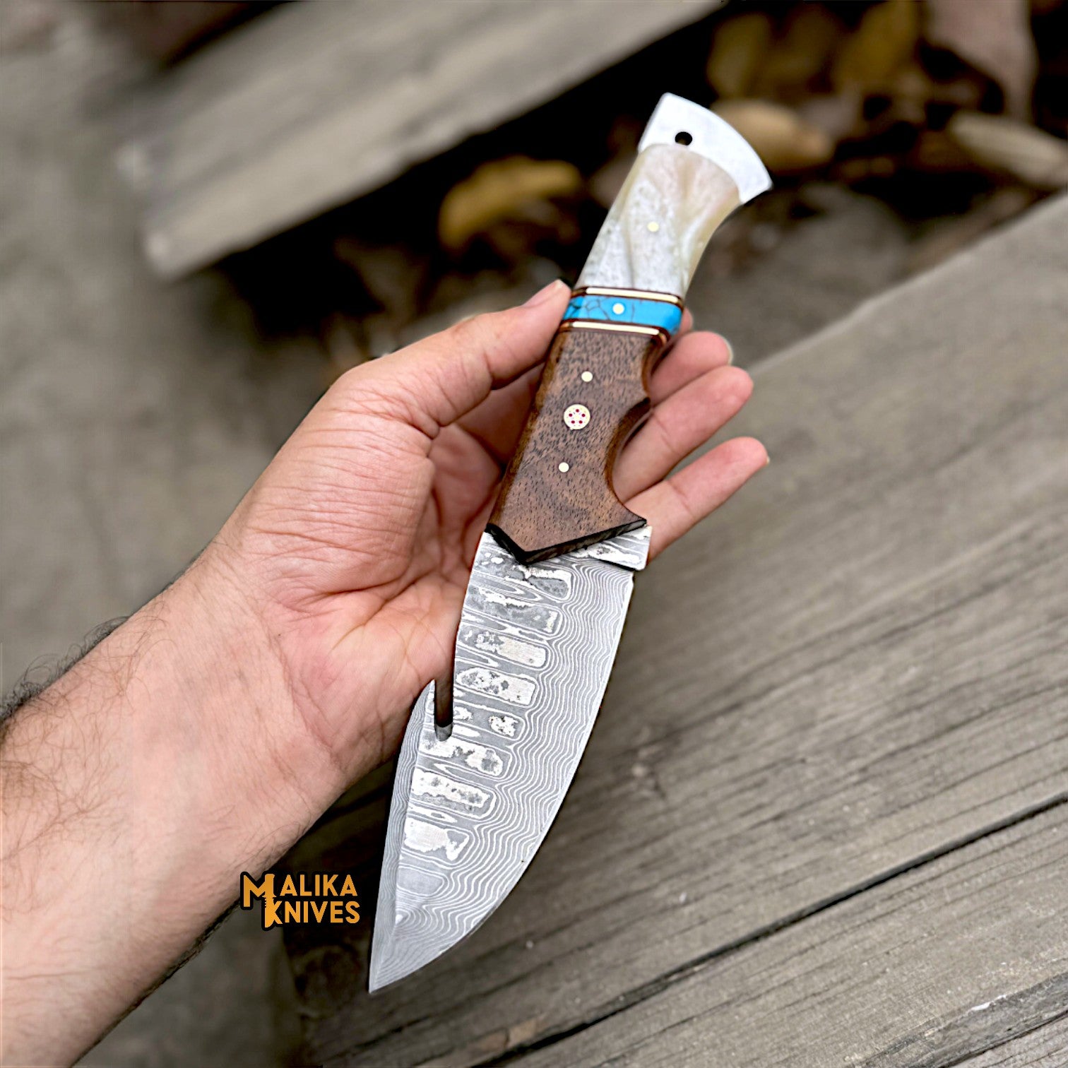 Stainless Damascus GutHook Hunting Knife in hand