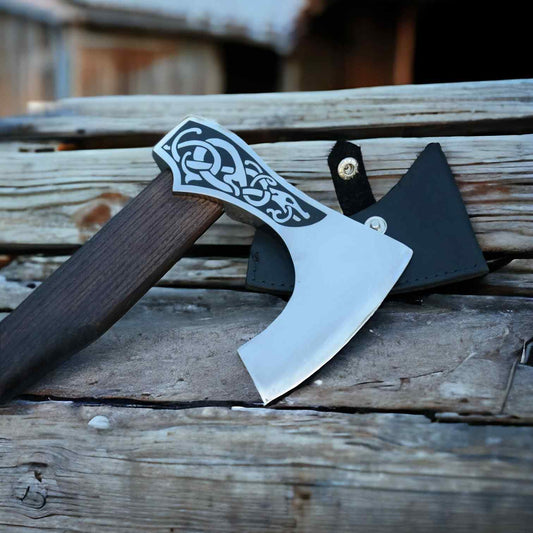 Norse serpent Viking axe with 1075 steel head beside a black leather blade sheath