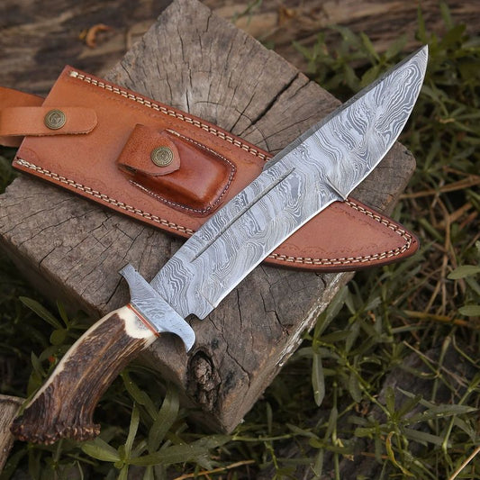 Damascus bowie knife with a leather sheath on a wooden surface
