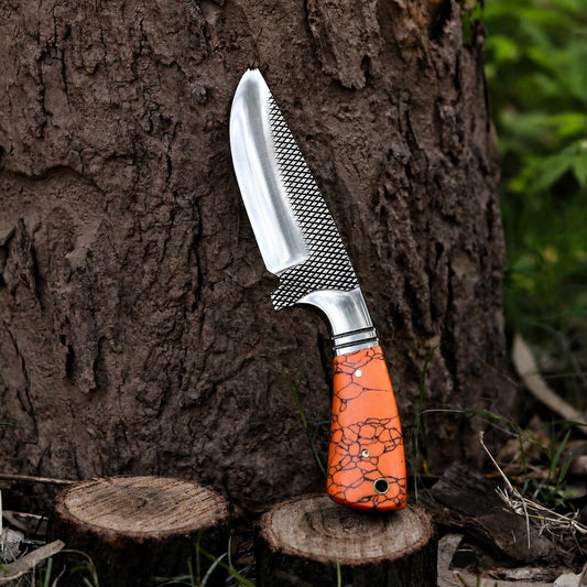 Turquoise marble handle close-up with steel bolster on hunting knife