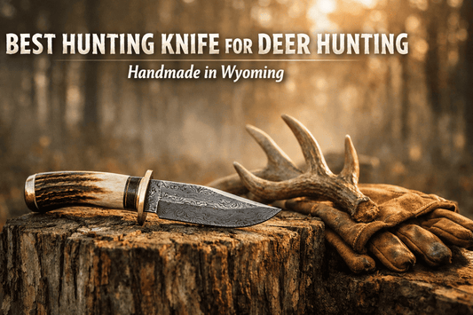 Handmade Damascus hunting knife resting on a tree stump in forest setting for deer hunting