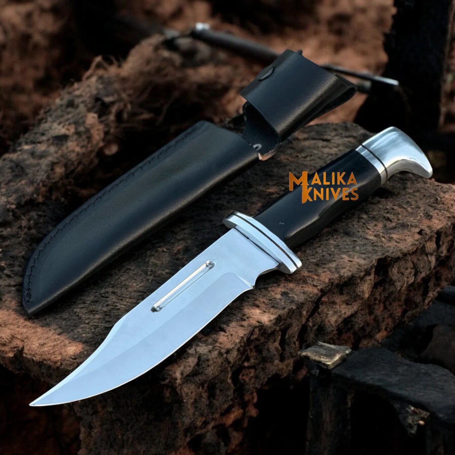 A Clip-Point Bowie Knife with a D2 steel blade and G10 handle, accompanied by a leather sheath, displayed on a rugged outdoor background.