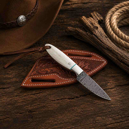 Buckaroo Damascus steel knife with camel bone handle, Western fixed blade design, and decorative brass details