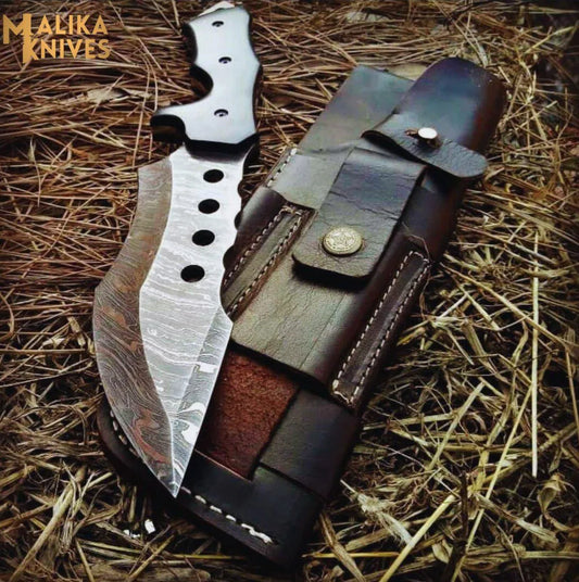 A custom tracker Bowie knife with a G10 Micarta handle, Damascus steel blade, and a Cowhide leather sheath.