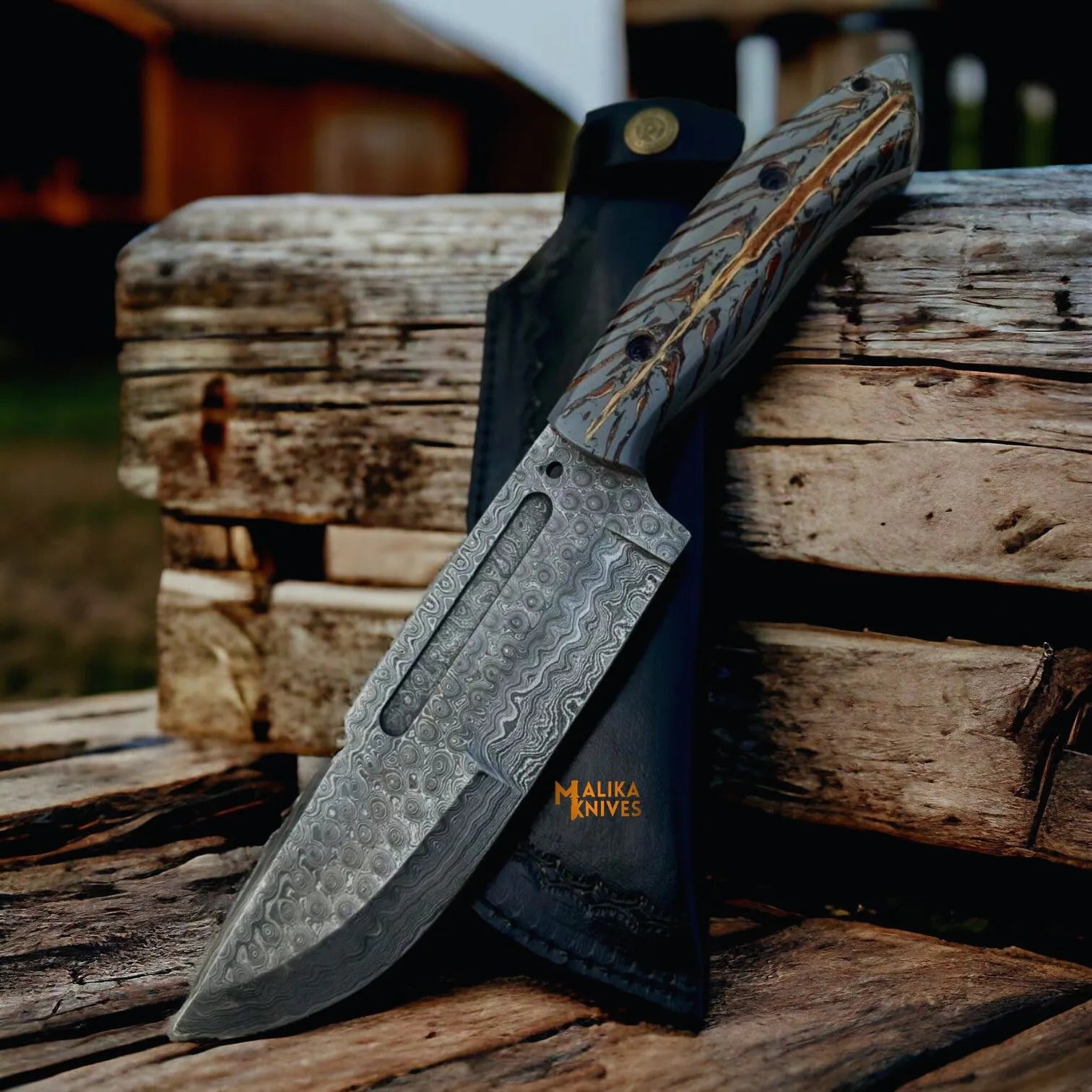 Damascus Bowie knife picture with pine cone resin handle and leather sheath on wood