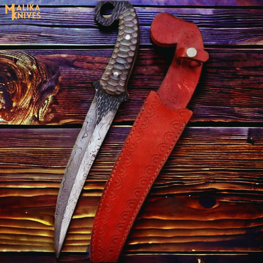 Hand forged Damascus Ringtail Hunting Knife Micarta handle and leather sheath on a wooden surface, brand 'Malika Knives' visible.
