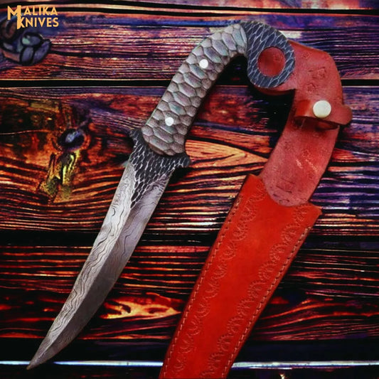 Hand forged Damascus Ringtail Hunting Knife Micarta handle and leather sheath on a wooden surface, brand 'Malika Knives' visible.