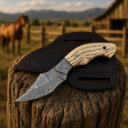 Ashwood handle close-up with Damascus cowboy knife with bolster detail