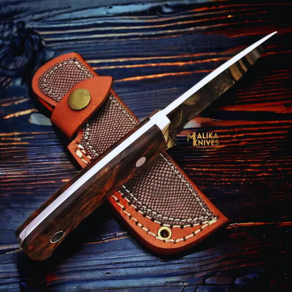 compact handmade d2 hunting knife with rosewood handle and stainless steel guard on wooden background