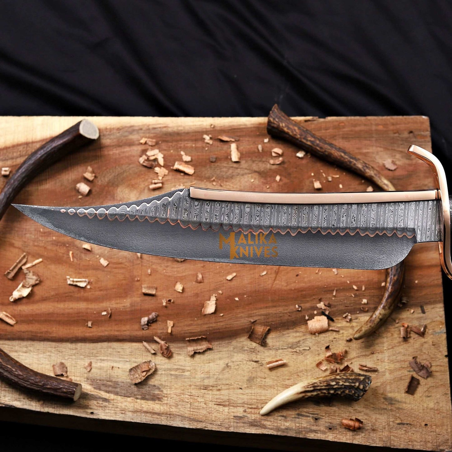 Blade closeup of copper damascus alamo musso bowie knife 