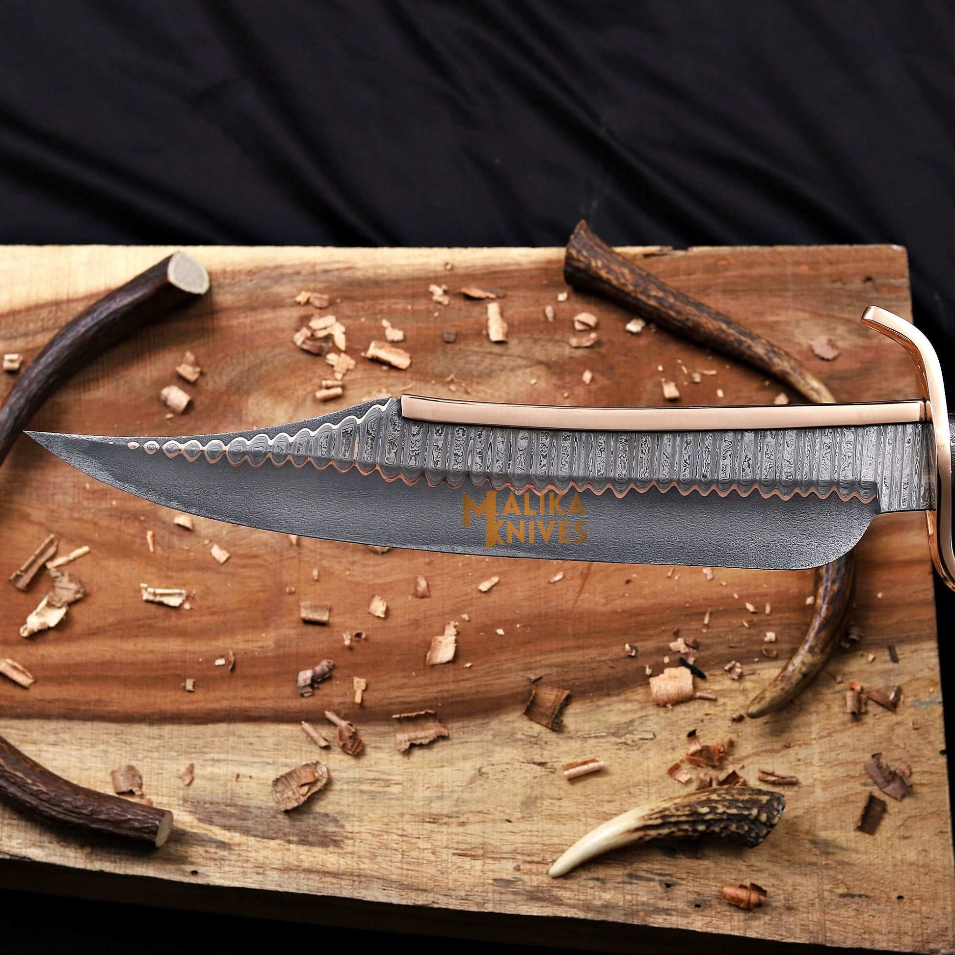 Blade closeup of copper damascus alamo musso bowie knife 