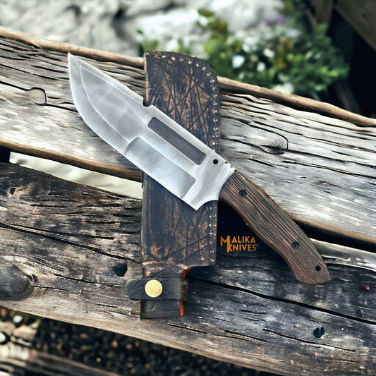 Knife with wooden handle and transparent blade on a wooden surface, featuring 'Malika Knives' branding.