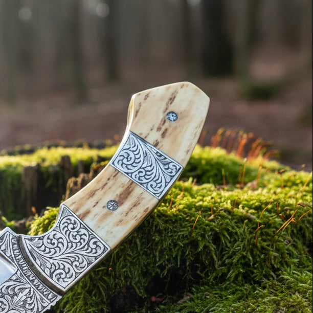 d2 hunting knife with antler horn handle and engraved bolster close up