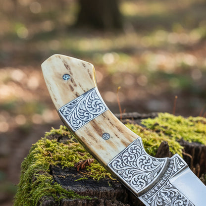 d2 hunting knife with antler horn handle and engraved bolster close up