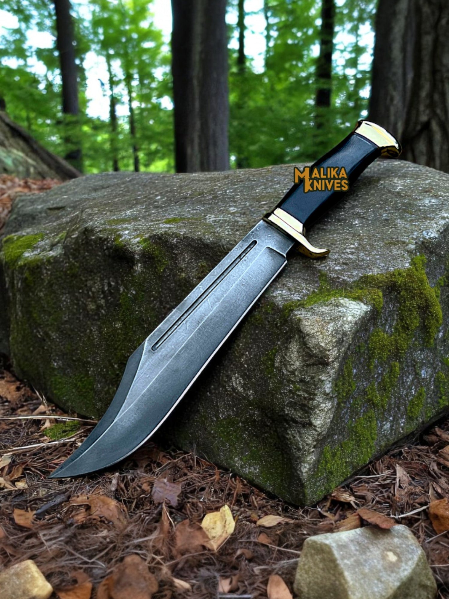 Knife with 'Malika Knives' branding on a rock in a forest setting