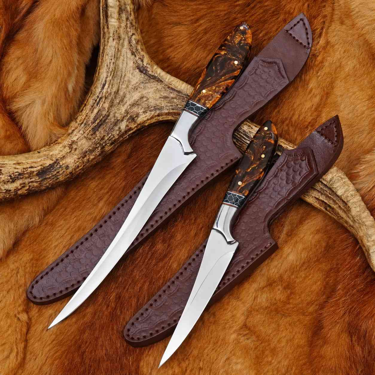 Handmade 440C stainless fillet and boning knife set with amber resin handles and tooled leather sheaths on deer hide
