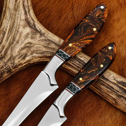 Close-up of fillet knife set amber resin handles with black honeycomb spacer, copper liner and brass pins