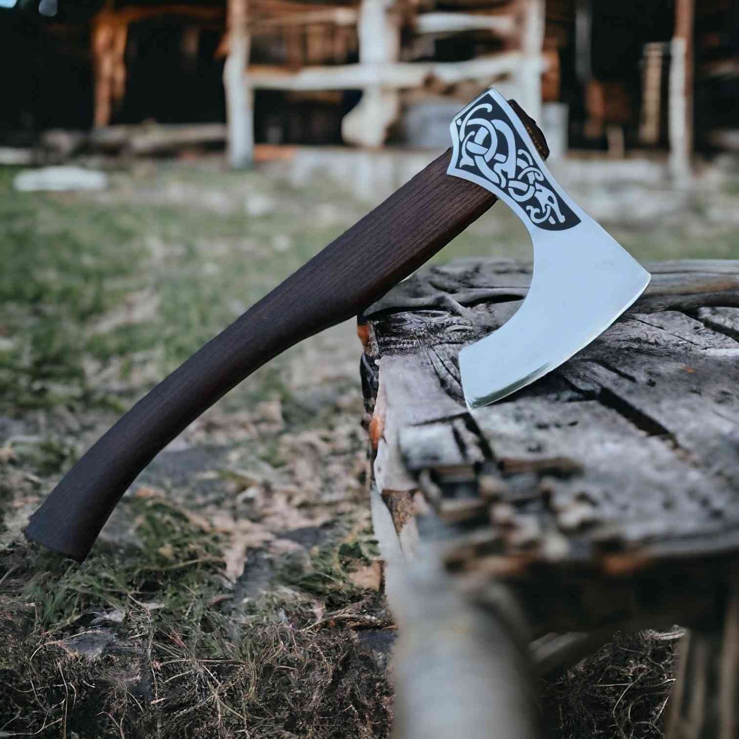 Hand-forged Viking serpent bearded axe with 1075 steel head and smooth rosewood handle on planks