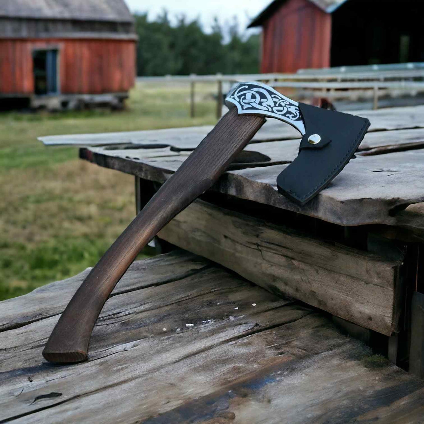 Handmade Viking serpent axe with rosewood handle and leather sheath on weathered wood