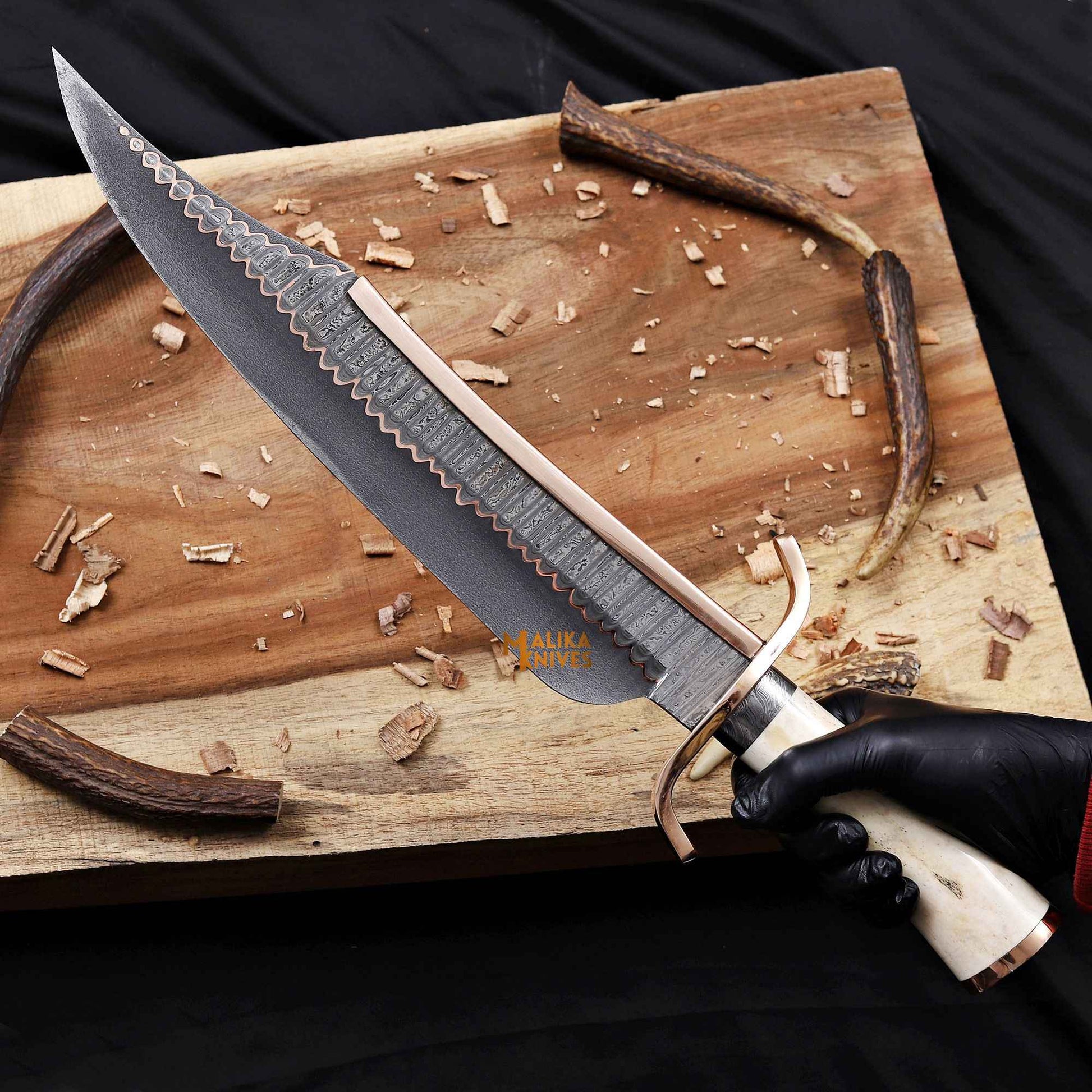 alamo musso Jim bowie knife  held in hand to showcase the grip.