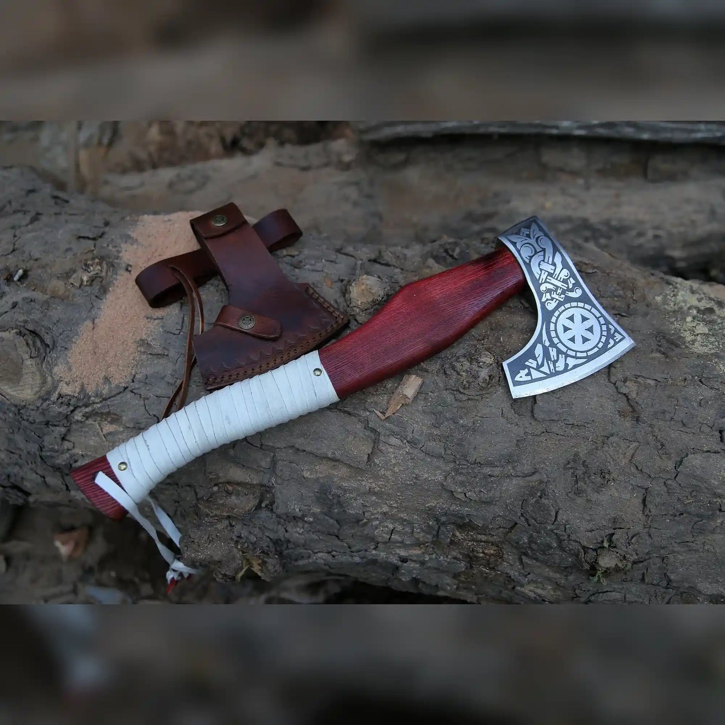Hand-forged Kolovrat sunwheel Viking axe with red wood handle, white leather wrap and brown leather sheath