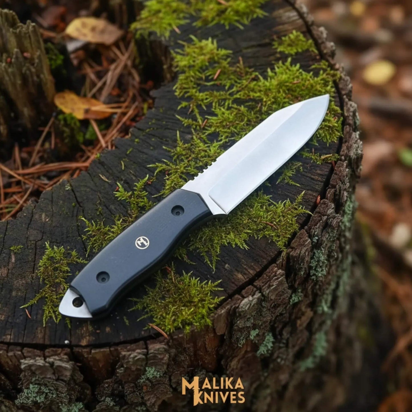 Sheepsfoot D2 hunting knife with black G10 handle and custom leather sheath on wooden surface