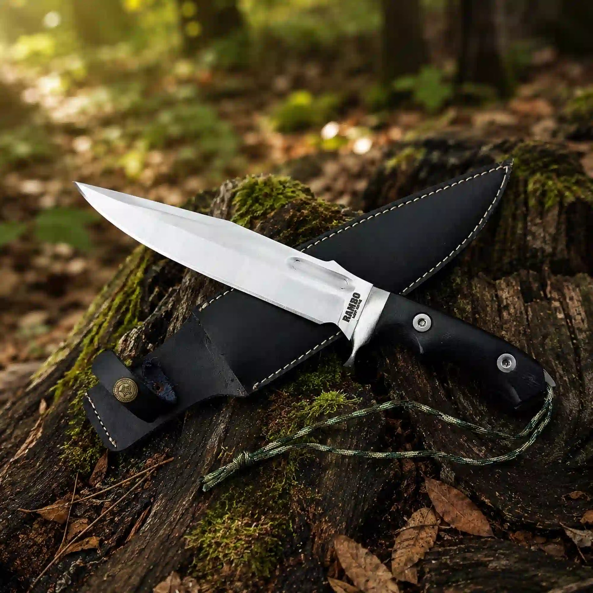 Rambo Last Blood D2 bowie knife with black leather sheath and compass medallion in the forest