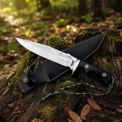 Rambo Last Blood D2 bowie knife with black leather sheath and compass medallion in the forest