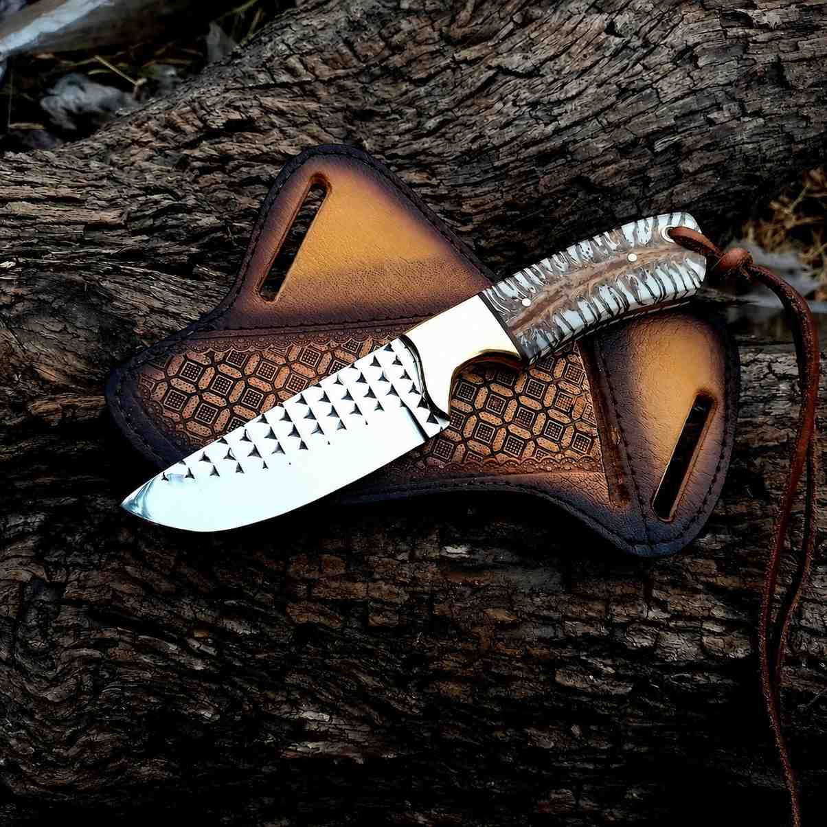 Handmade rasp steel cowboy knife with pine cone resin handle on a tooled leather crossdraw sheath