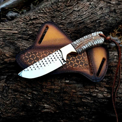 Handmade rasp steel cowboy knife with pine cone resin handle on a tooled leather crossdraw sheath