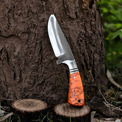 Turquoise marble handle close-up with steel bolster on hunting knife
