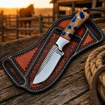 Western buckaroo knife with leather sheath at sunset